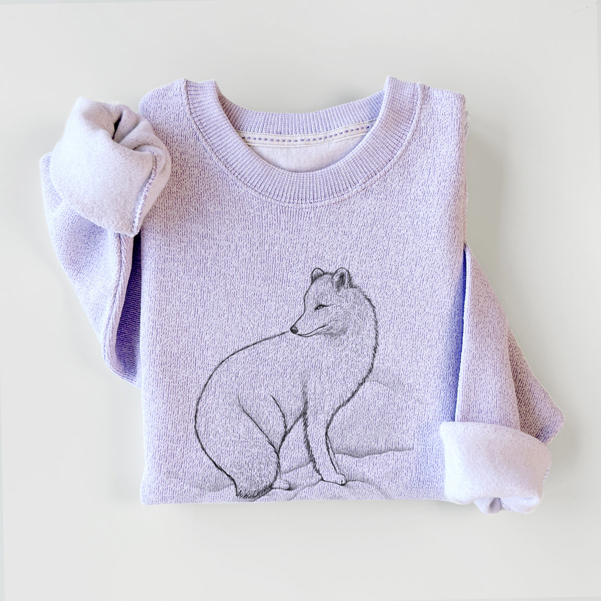 Ice purple knit sweatshirt printed with a black ink illustration of an arctic fox sitting in the snow, styled flat.