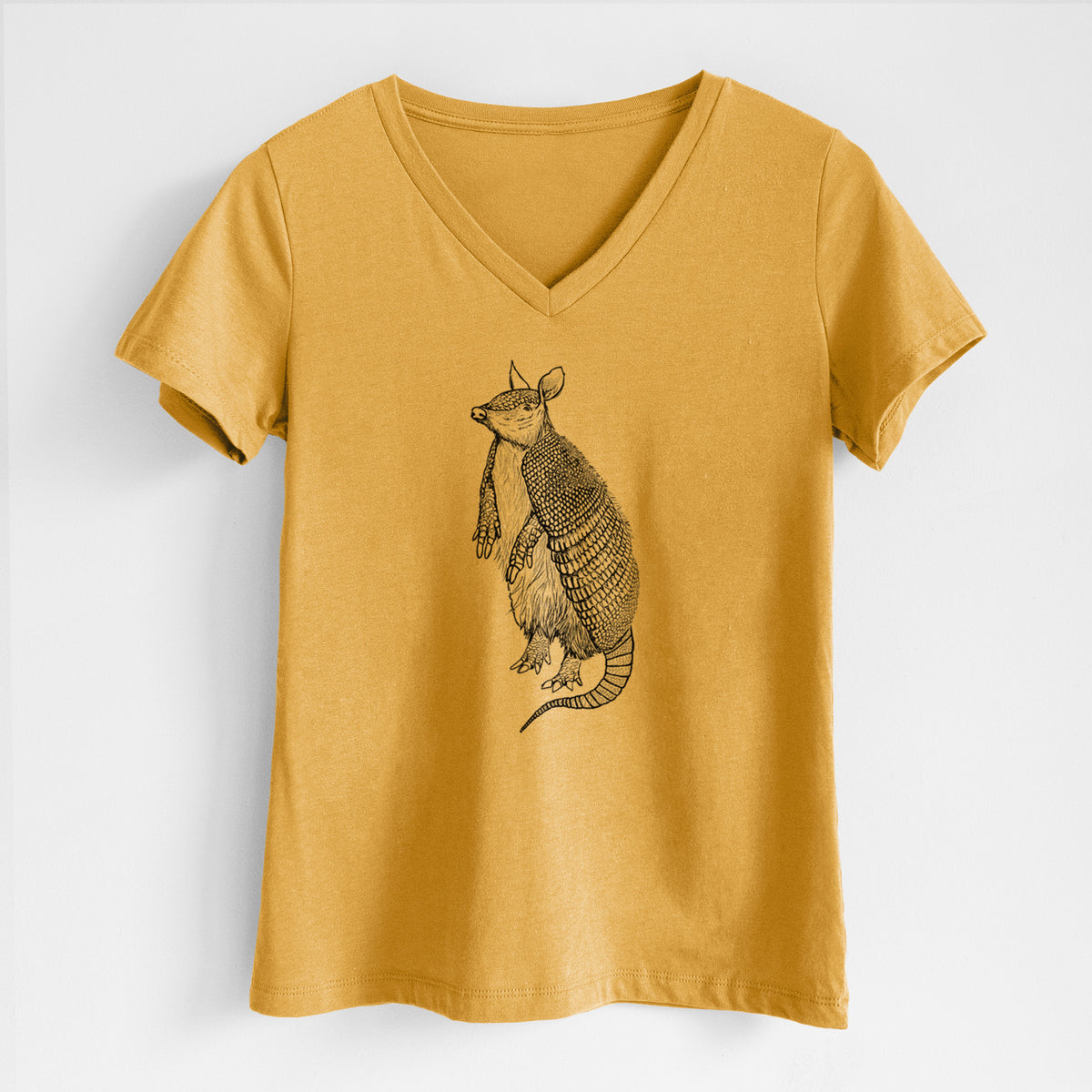 Honeycomb yellow women's relaxed fit cotton V-neck t-shirt laid flat, printed with a black ink illustration of a nine-banded armadillo standing upright.
