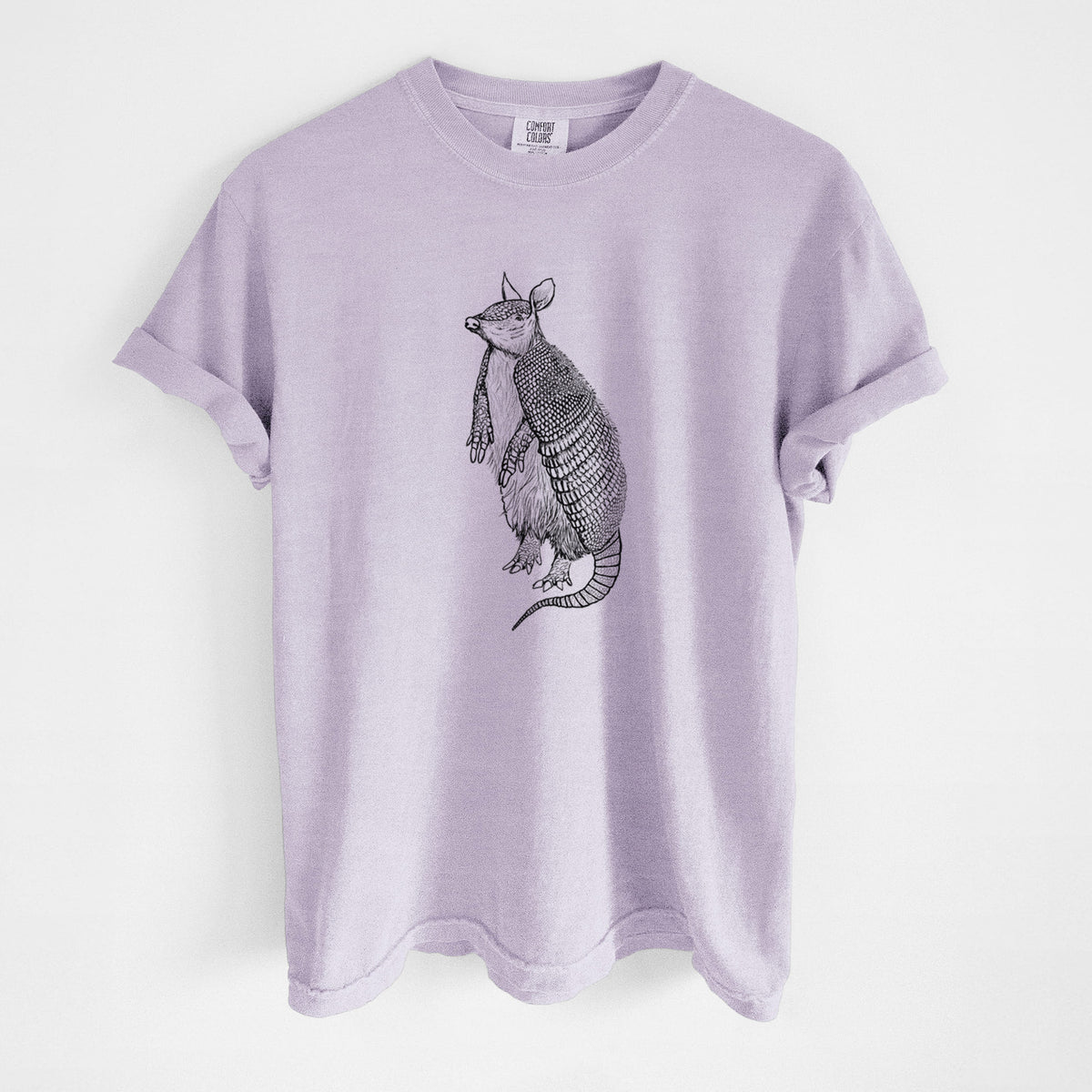 Orchid purple Comfort Colors t-shirt laid flat, printed with a black ink illustration of a nine-banded armadillo standing upright.