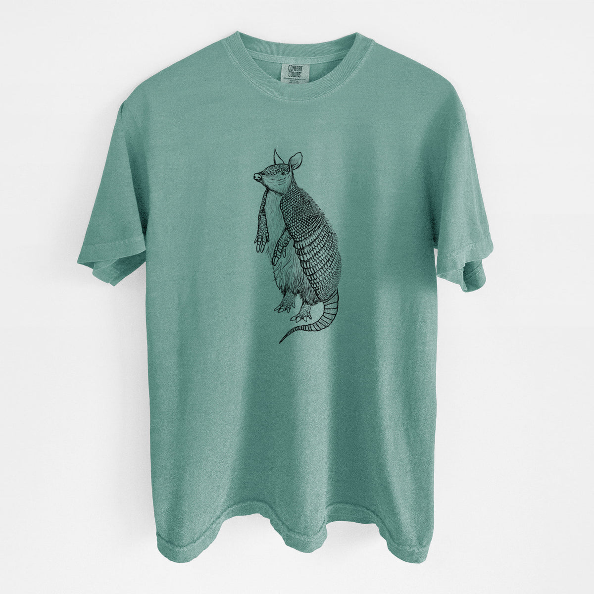 Reef green Comfort Colors t-shirt laid flat, printed with a black ink illustration of a nine-banded armadillo standing upright.