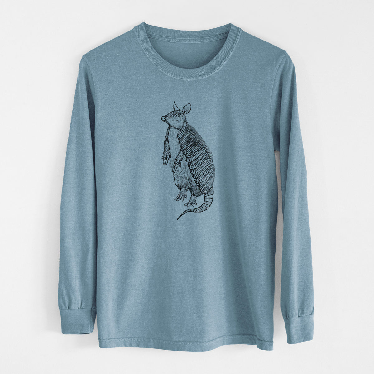 Steel blue Comfort Colors long sleeve shirt laid flat, printed with a black ink illustration of a nine-banded armadillo standing upright.