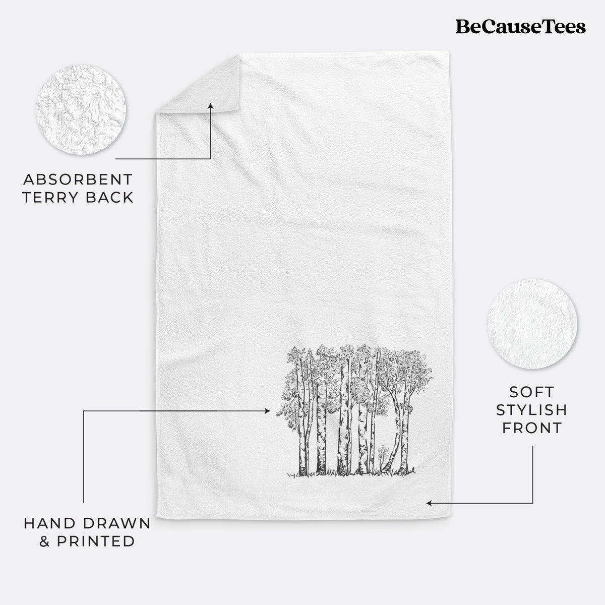 White hand towel printed with a black ink illustration of a grove of aspen trees.