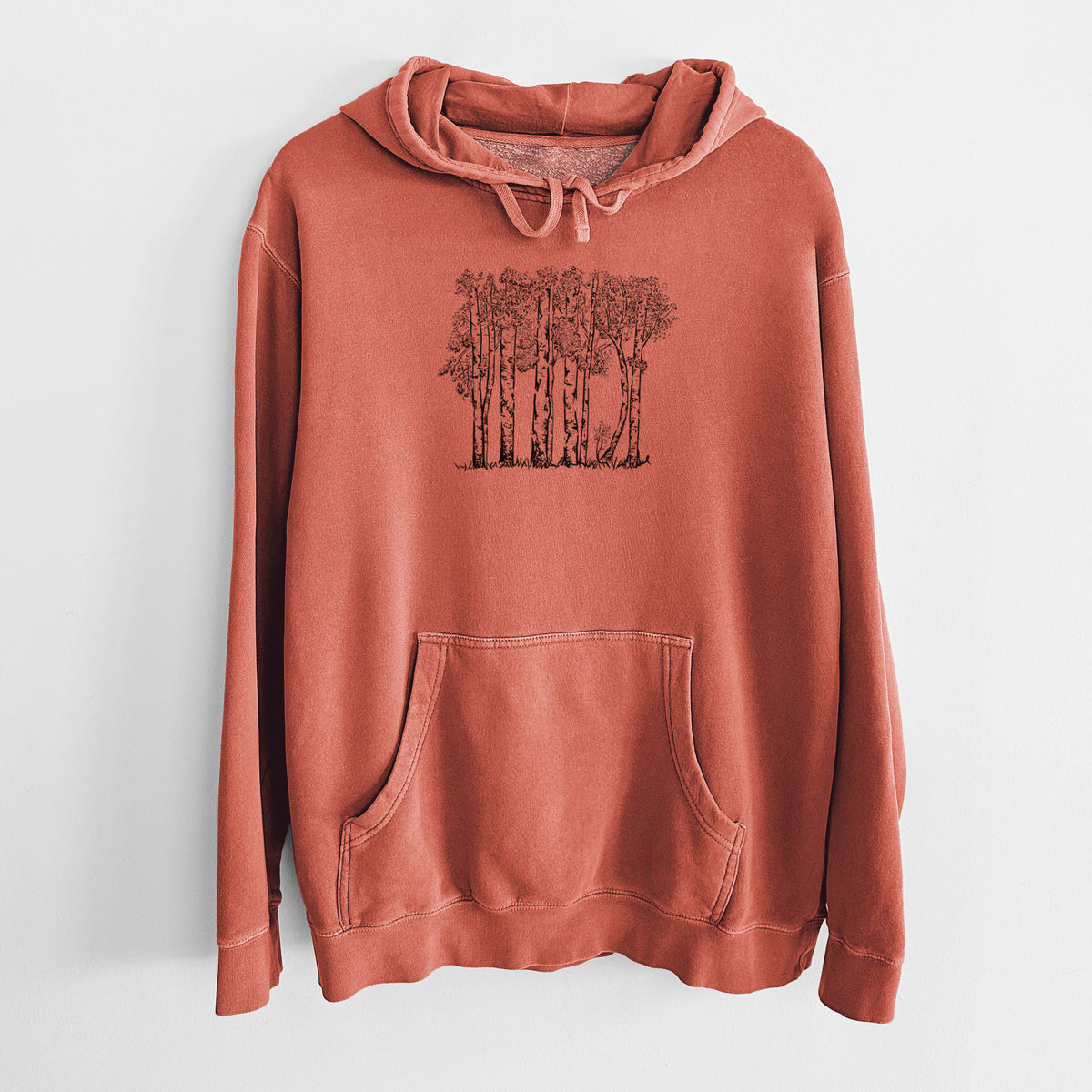 Amber orange pigment dyed hoodie laid flat, printed with a black ink illustration of a grove of aspen trees.