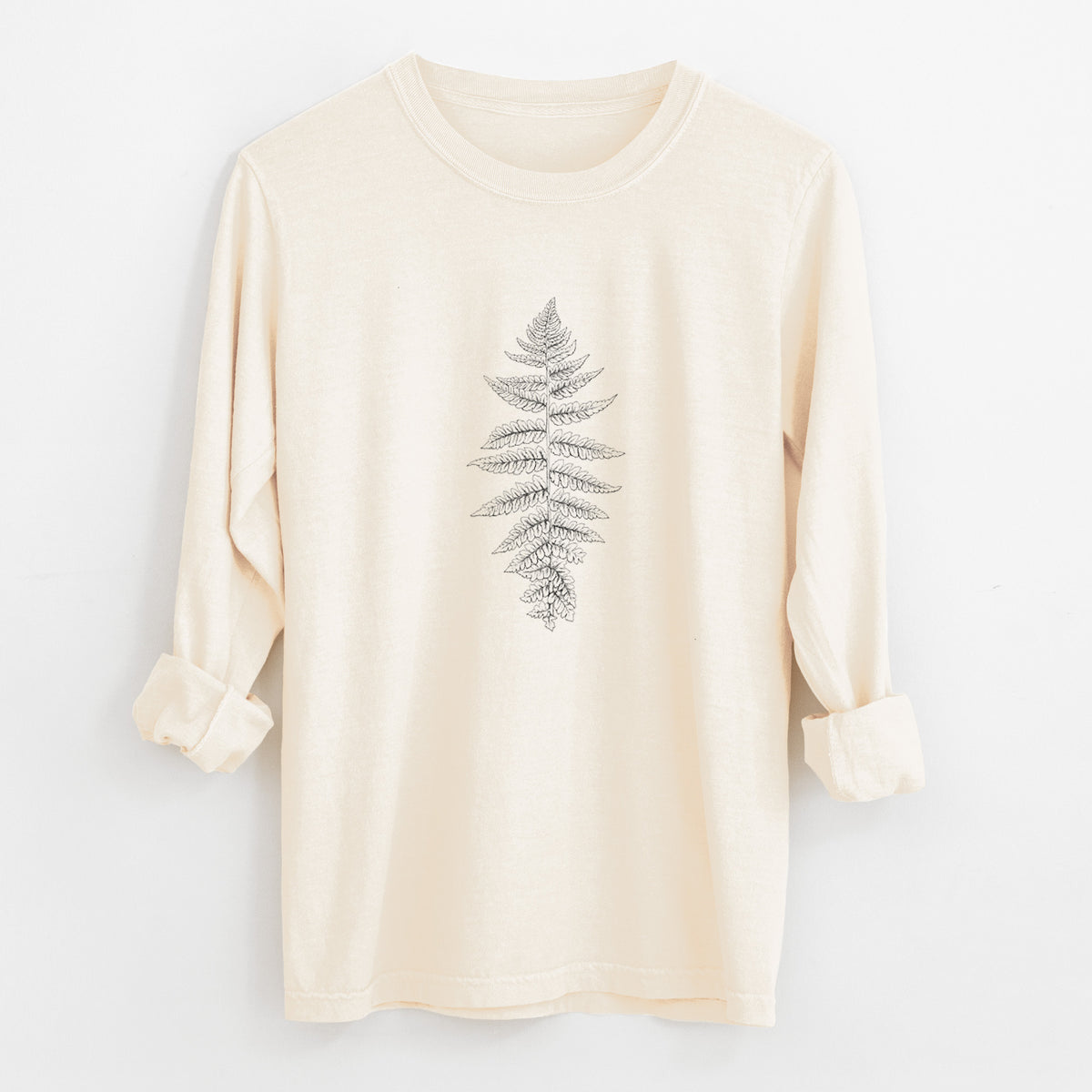 Ivory Comfort Colors long sleeve shirt laid flat with the cuffs rolled, printed with a black ink illustration of a lady fern frond.