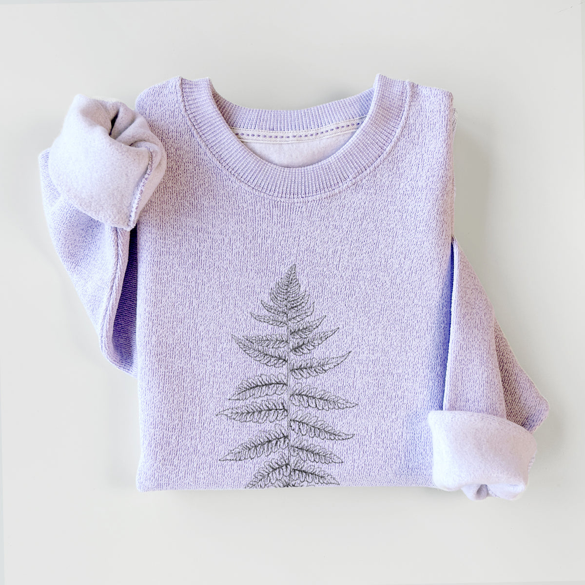 Ice purple knit sweatshirt printed with a black ink illustration of a lady fern frond, styled flat.