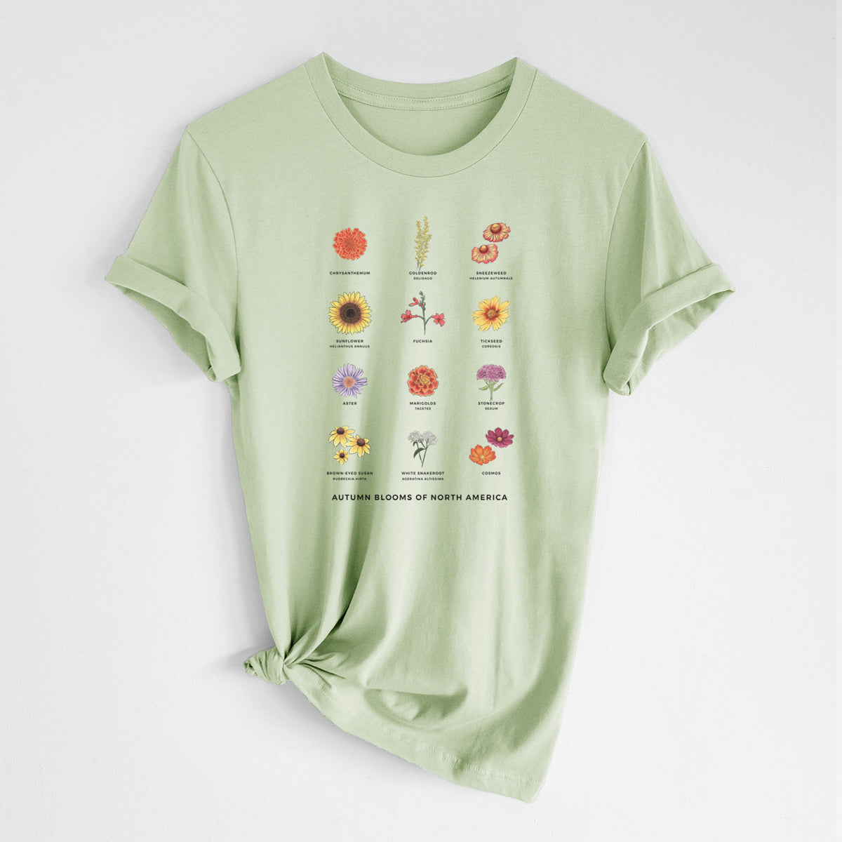 Spring green lightweight cotton t-shirt laid flat with the sleeves rolled, printed with a full-color chart of autumn flowers, each labeled with its name.