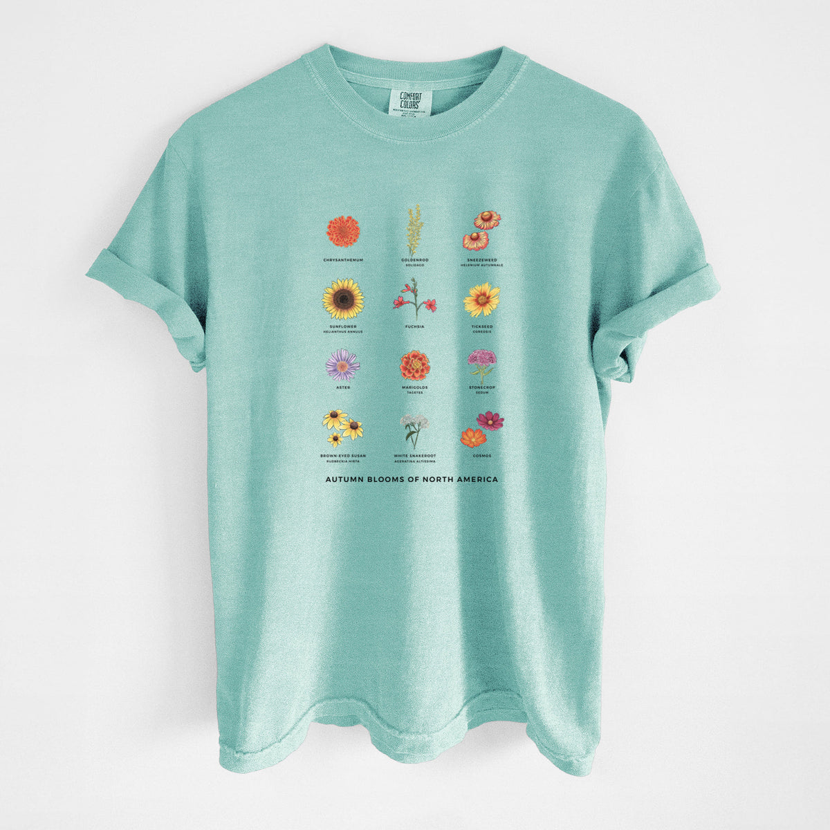 Chalky mint Comfort Colors t-shirt laid flat, printed with a full-color chart of autumn flowers, each labeled with its name.
