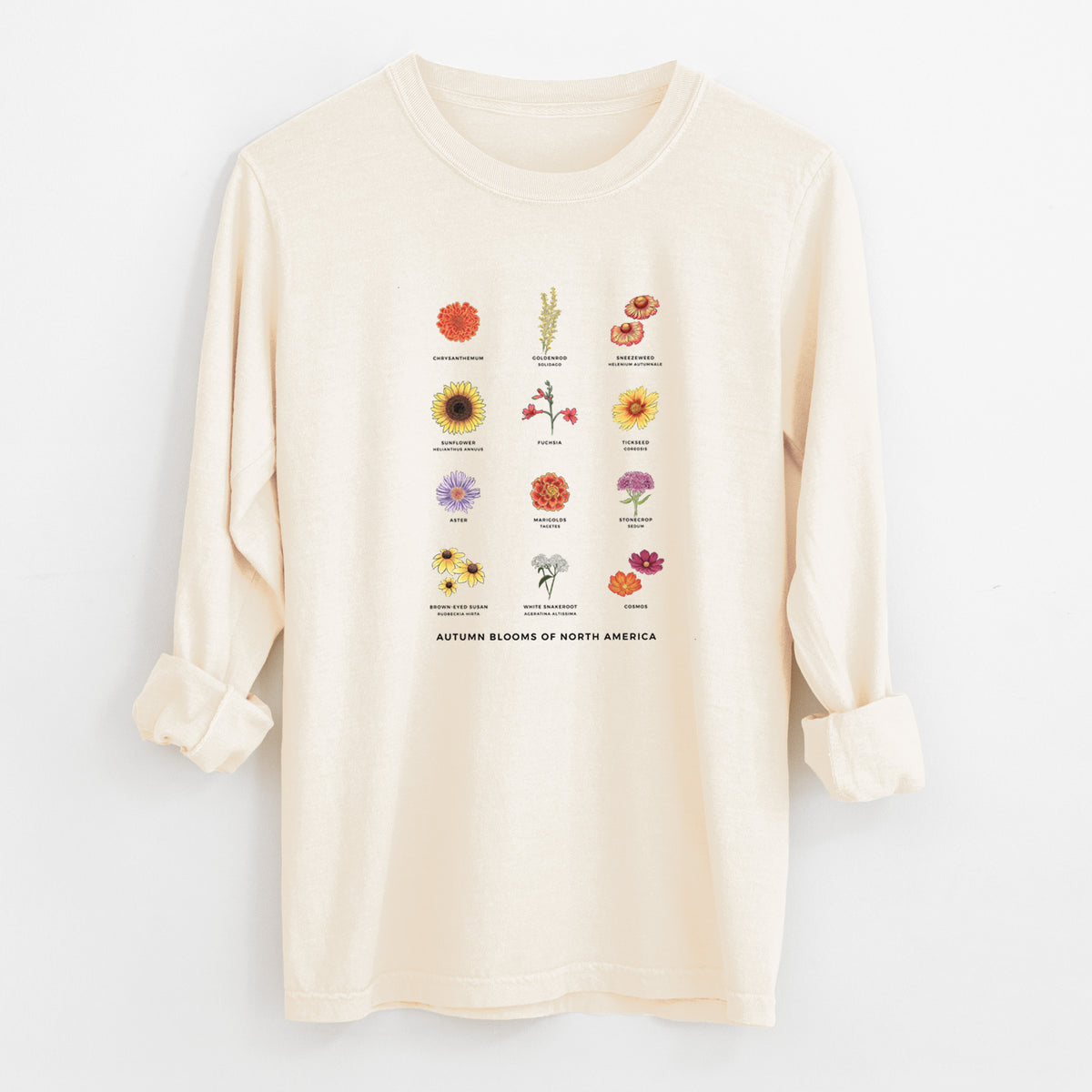 Ivory Comfort Colors long sleeve shirt laid flat with the cuffs rolled, printed with a full-color chart of autumn flowers, each labeled with its name.