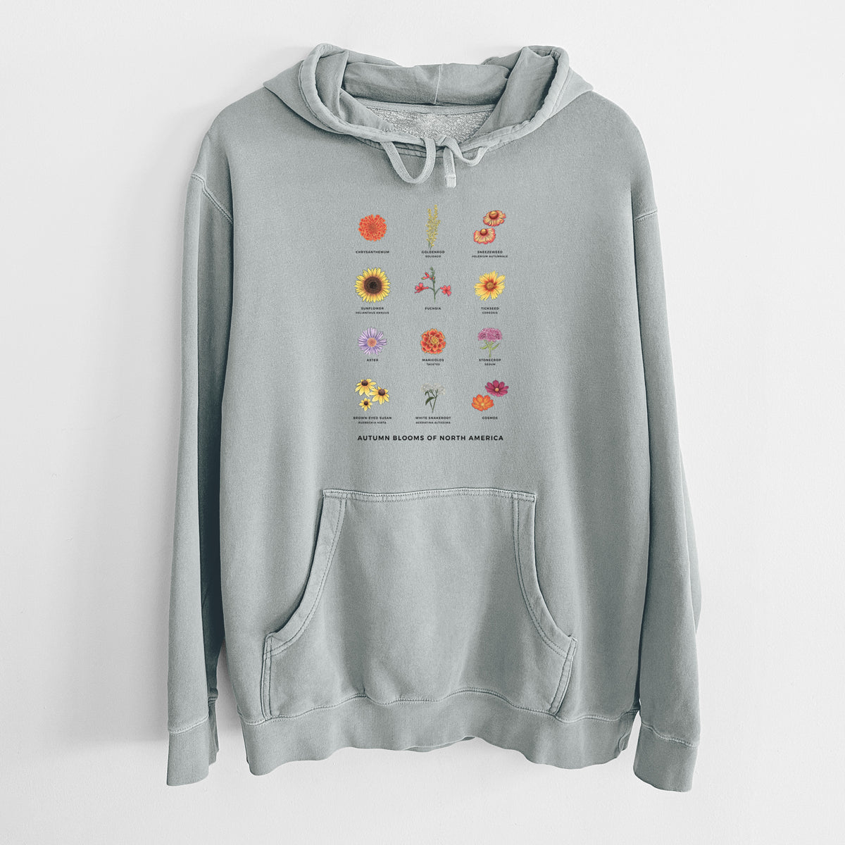 Sage green pigment dyed hoodie laid flat, printed with a full-color chart of autumn flowers, each labeled with its name.