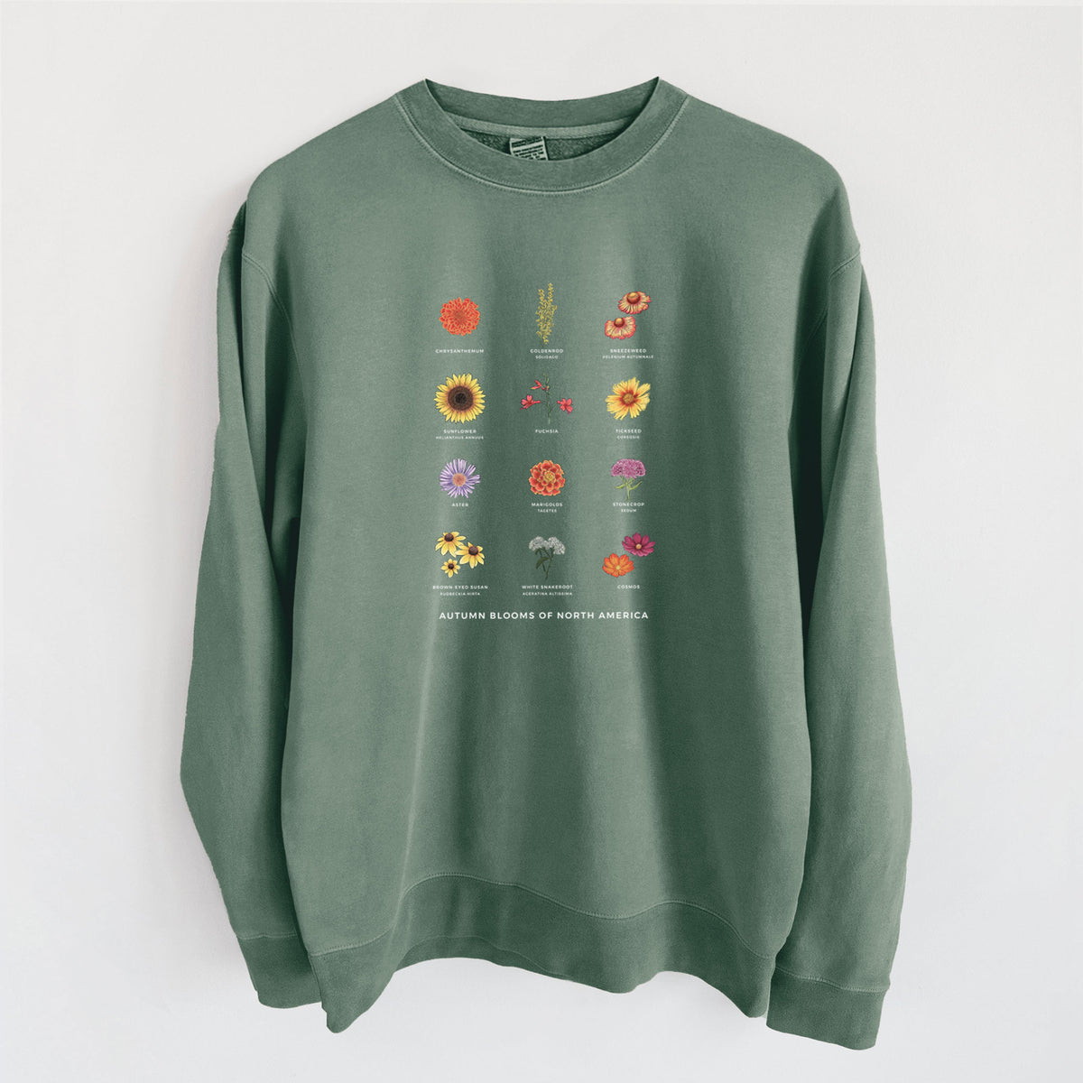 Alpine green pigment dyed crewneck sweatshirt laid flat, printed with a full-color chart of autumn flowers, each labeled with its name.