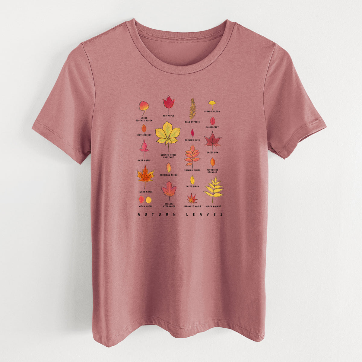 Mauve pink women's relaxed fit cotton t-shirt laid flat, printed with a full-color chart of autumn leaves, each labeled with its tree species.