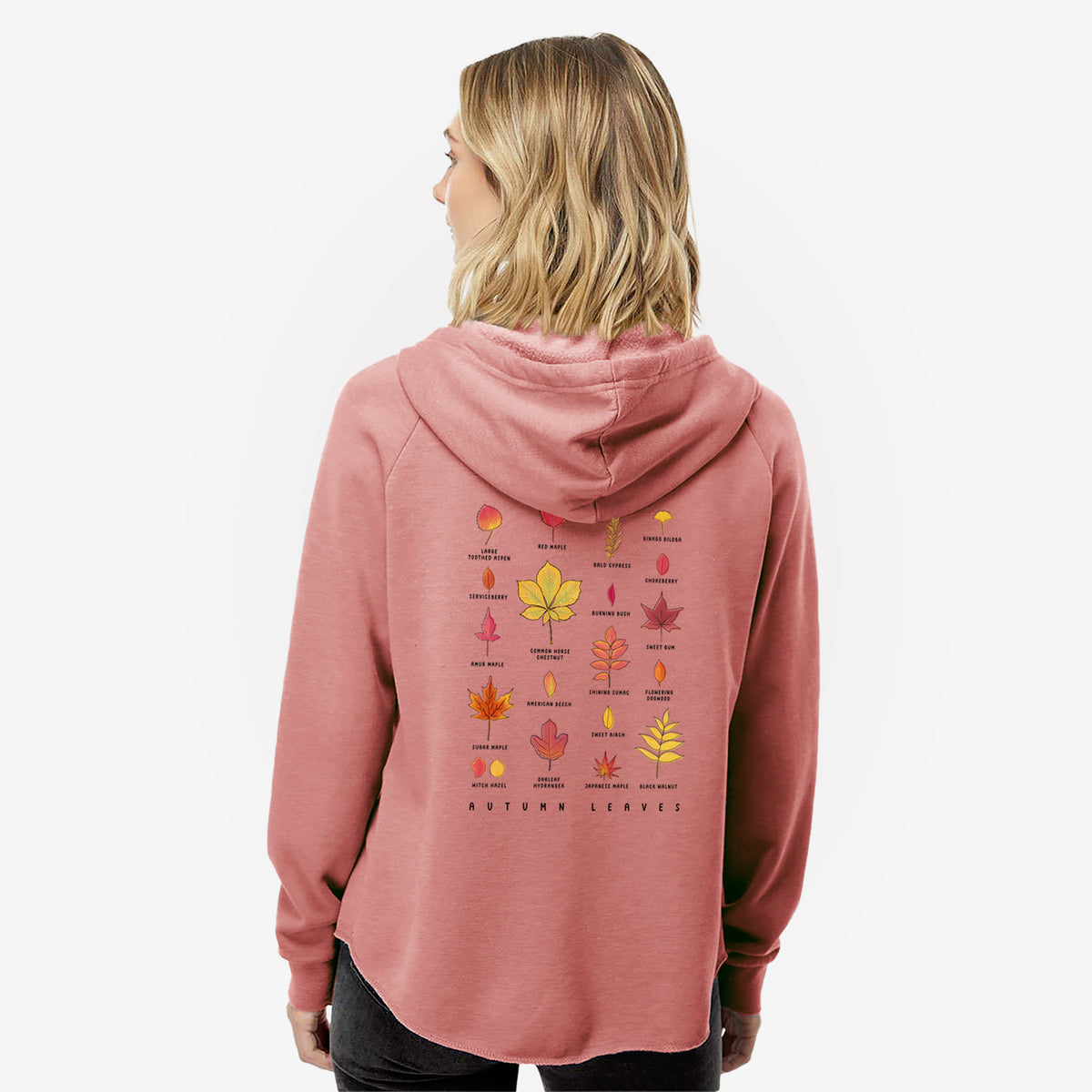 Woman wearing a dusty rose women's Cali Wave zip-up sweatshirt printed with a full-color chart of autumn leaves, each labeled with its tree species, seen from behind.