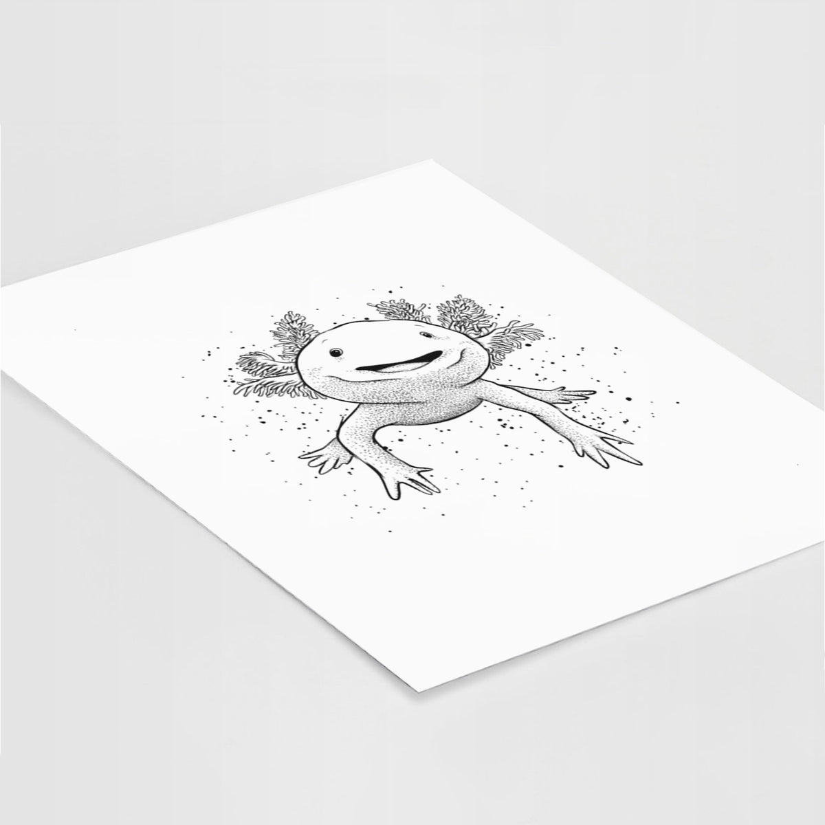 Art print of a black ink illustration of a smiling axolotl with feathery gills, lying at an angle on a white surface.