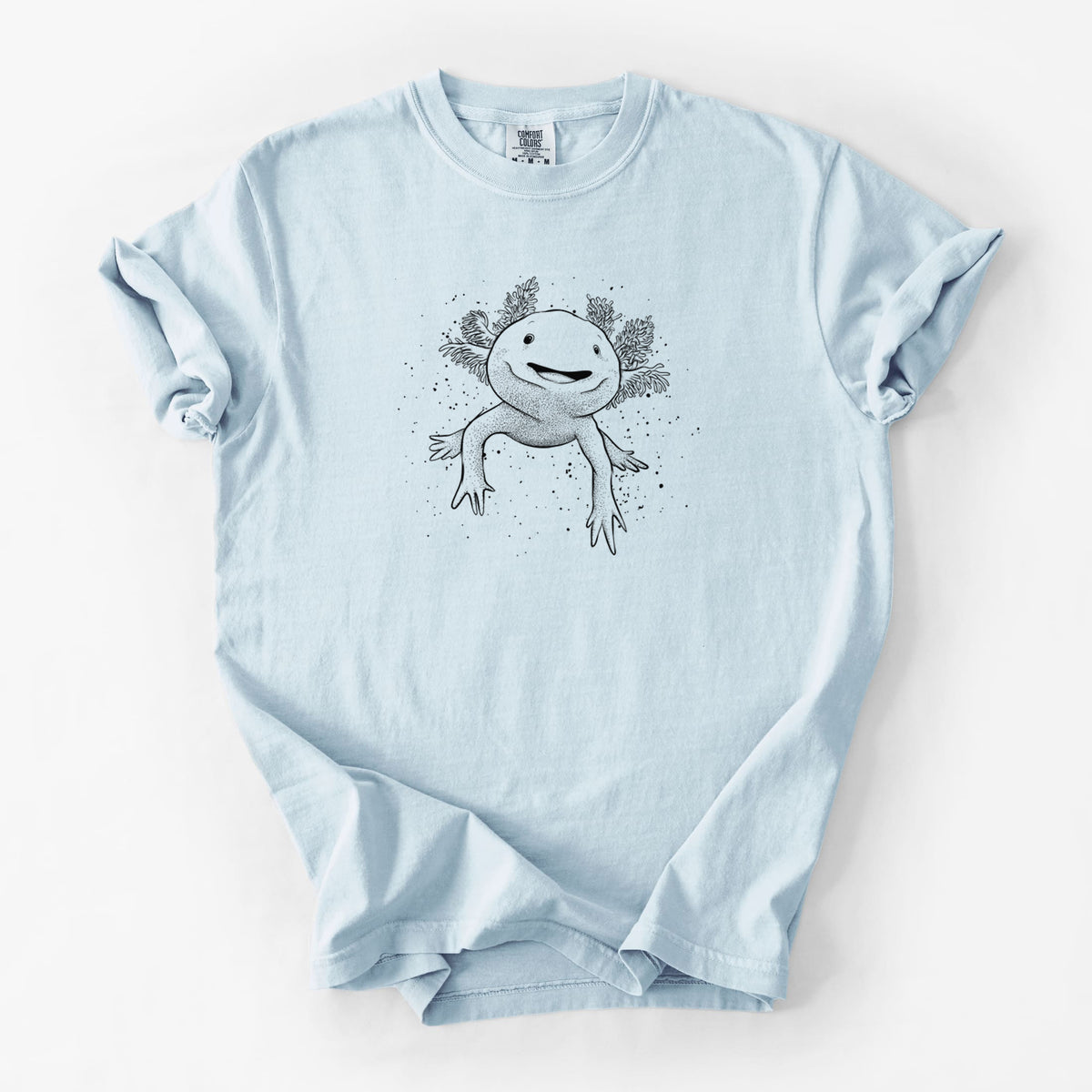 Chambray blue Comfort Colors t-shirt laid flat, printed with a black ink illustration of a smiling axolotl with feathery gills.