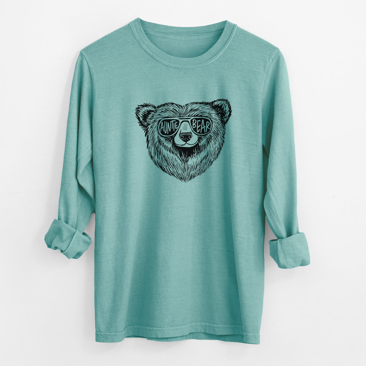 Reef green Comfort Colors long sleeve shirt laid flat with the cuffs rolled, printed with a black ink bear's face wearing sunglasses that read Auntie Bear.
