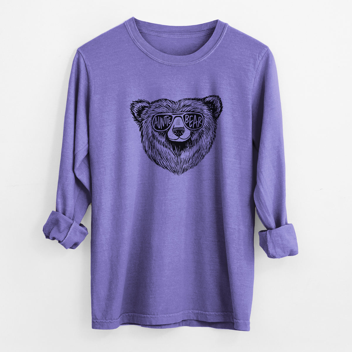 Violet purple Comfort Colors long sleeve shirt laid flat with the cuffs rolled, printed with a black ink bear's face wearing sunglasses that read Auntie Bear.
