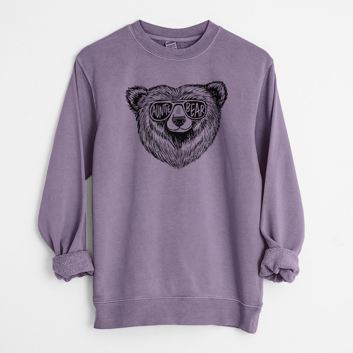 Plum purple pigment dyed crewneck sweatshirt laid flat with the sleeves rolled, printed with a black ink bear's face wearing sunglasses that read Auntie Bear.