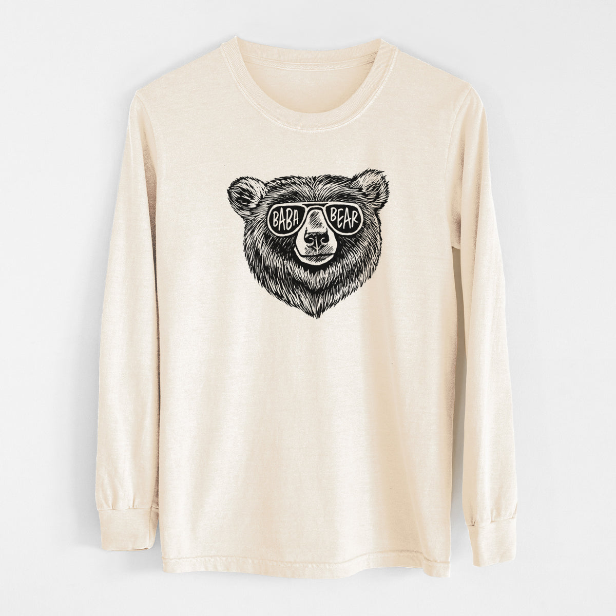 Ivory Comfort Colors long sleeve shirt laid flat, printed with a black ink bear's face wearing sunglasses that read Baba Bear.