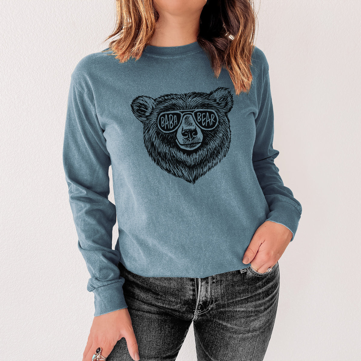 Steel blue Comfort Colors long sleeve shirt printed with a black ink bear's face wearing sunglasses that read Baba Bear, shown in a lifestyle photo.