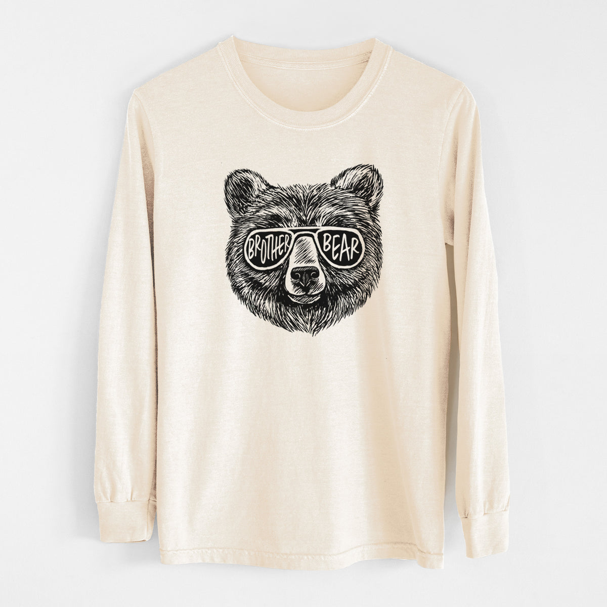 Ivory Comfort Colors long sleeve shirt laid flat, printed with a black ink bear's face wearing sunglasses that read Brother Bear.
