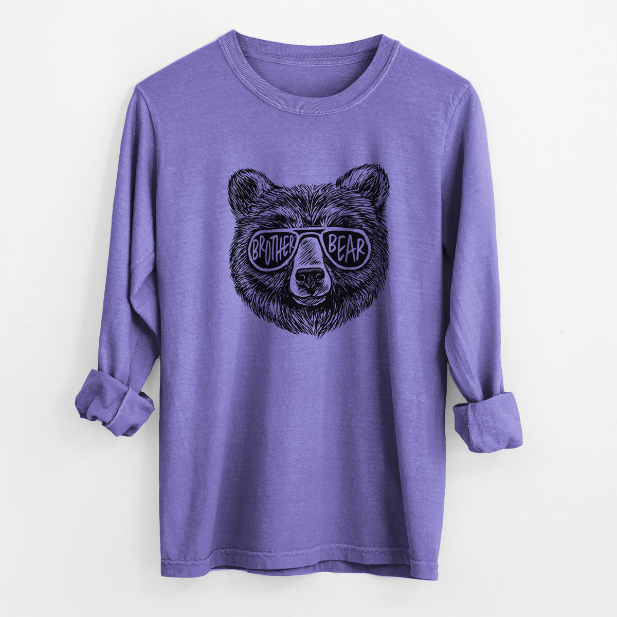 Violet purple Comfort Colors long sleeve shirt laid flat with the cuffs rolled, printed with a black ink bear's face wearing sunglasses that read Brother Bear.