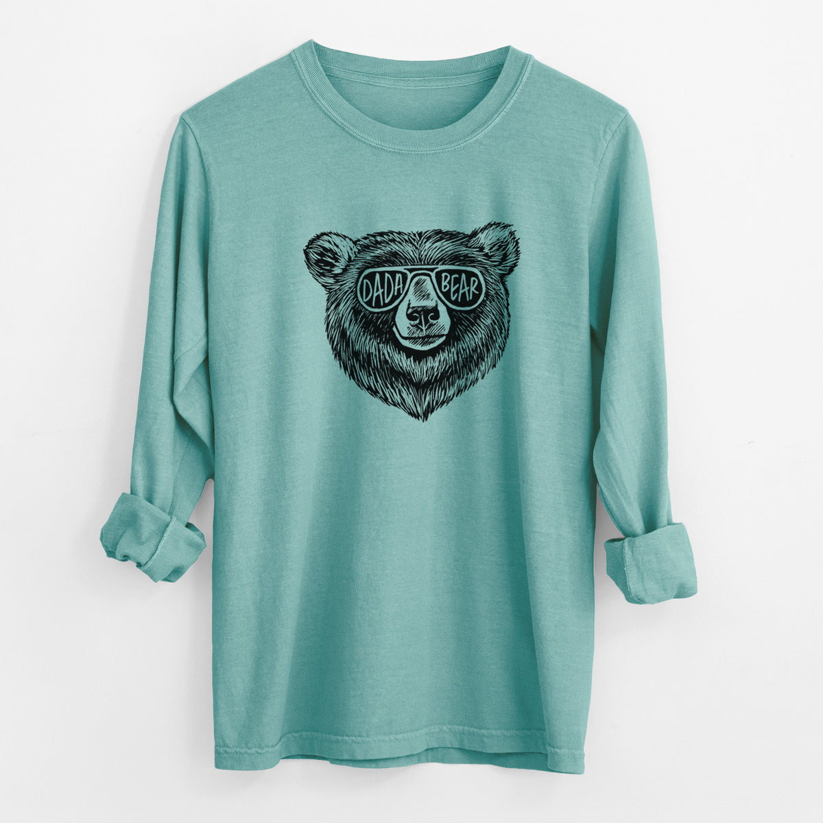 Reef green Comfort Colors long sleeve shirt laid flat with the cuffs rolled, printed with a black ink bear's face wearing sunglasses that read Dada Bear.