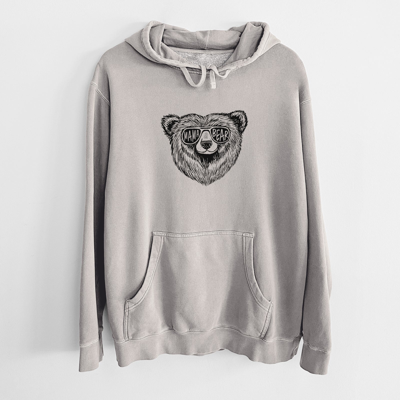 Cement grey pigment dyed hoodie laid flat, printed with a black ink bear's face wearing sunglasses that read Mama Bear.