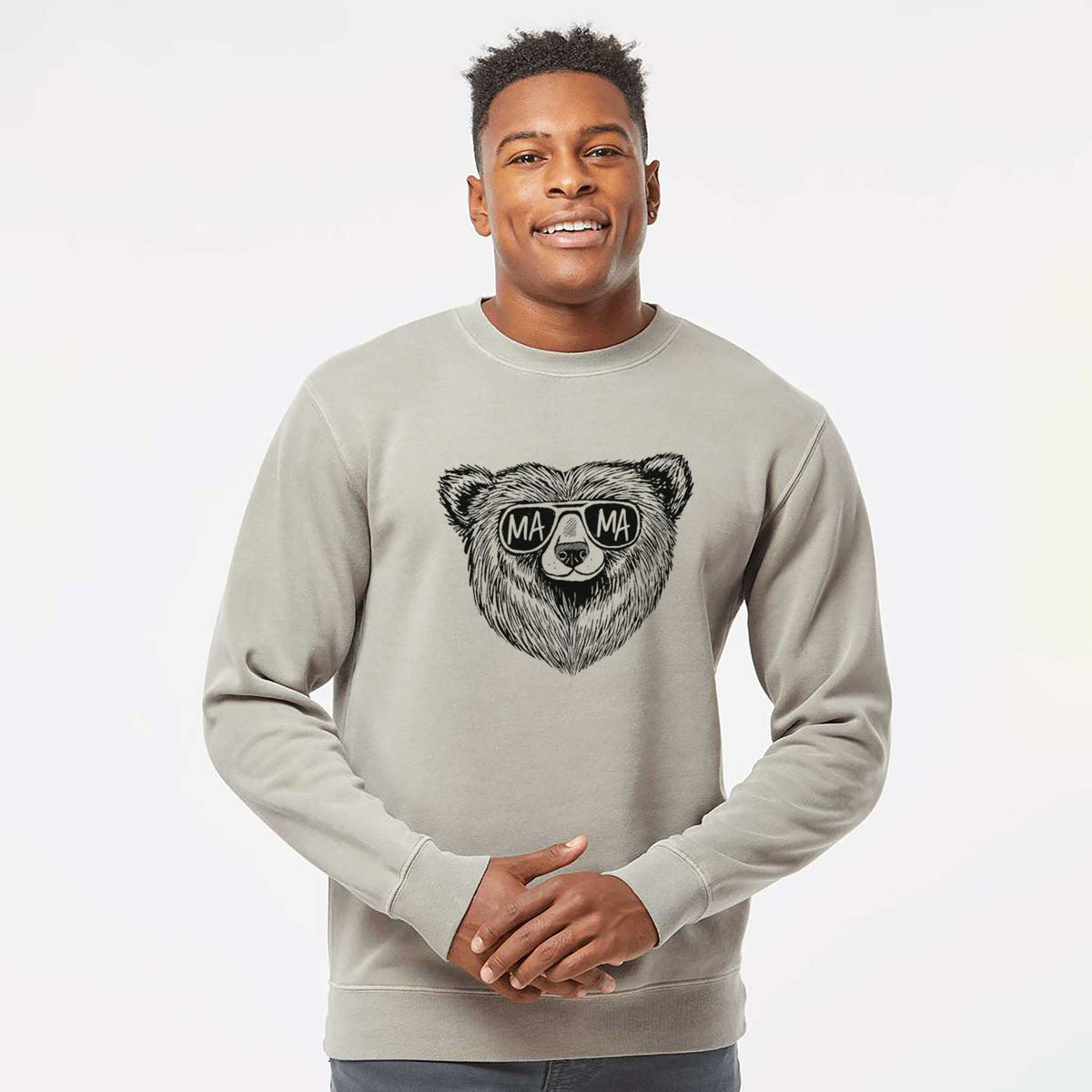 Model wearing a cement grey pigment dyed crewneck sweatshirt printed with a black ink bear's face wearing sunglasses that read Mama.