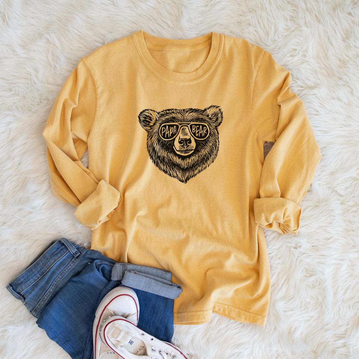 Golden wheat yellow Comfort Colors long sleeve shirt printed with a black ink bear's face wearing sunglasses that read Papa Bear, shown in a lifestyle photo.