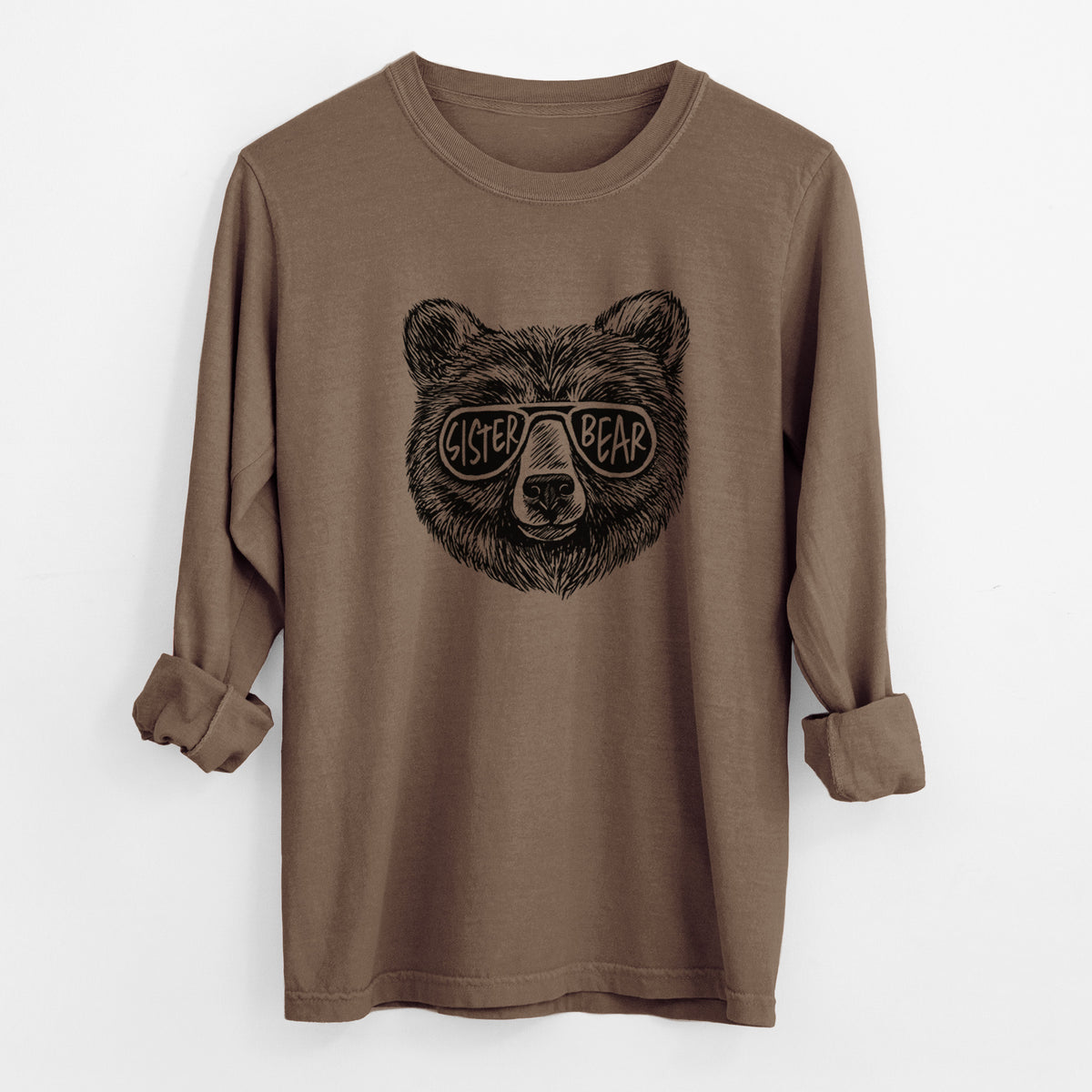 Espresso brown Comfort Colors long sleeve shirt laid flat with the cuffs rolled, printed with a black ink bear's face wearing sunglasses that read Sister Bear.