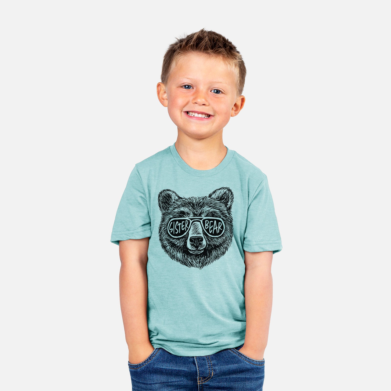 Basil green youth t-shirt laid flat, printed with a black ink bear's face wearing sunglasses that read Sister Bear.