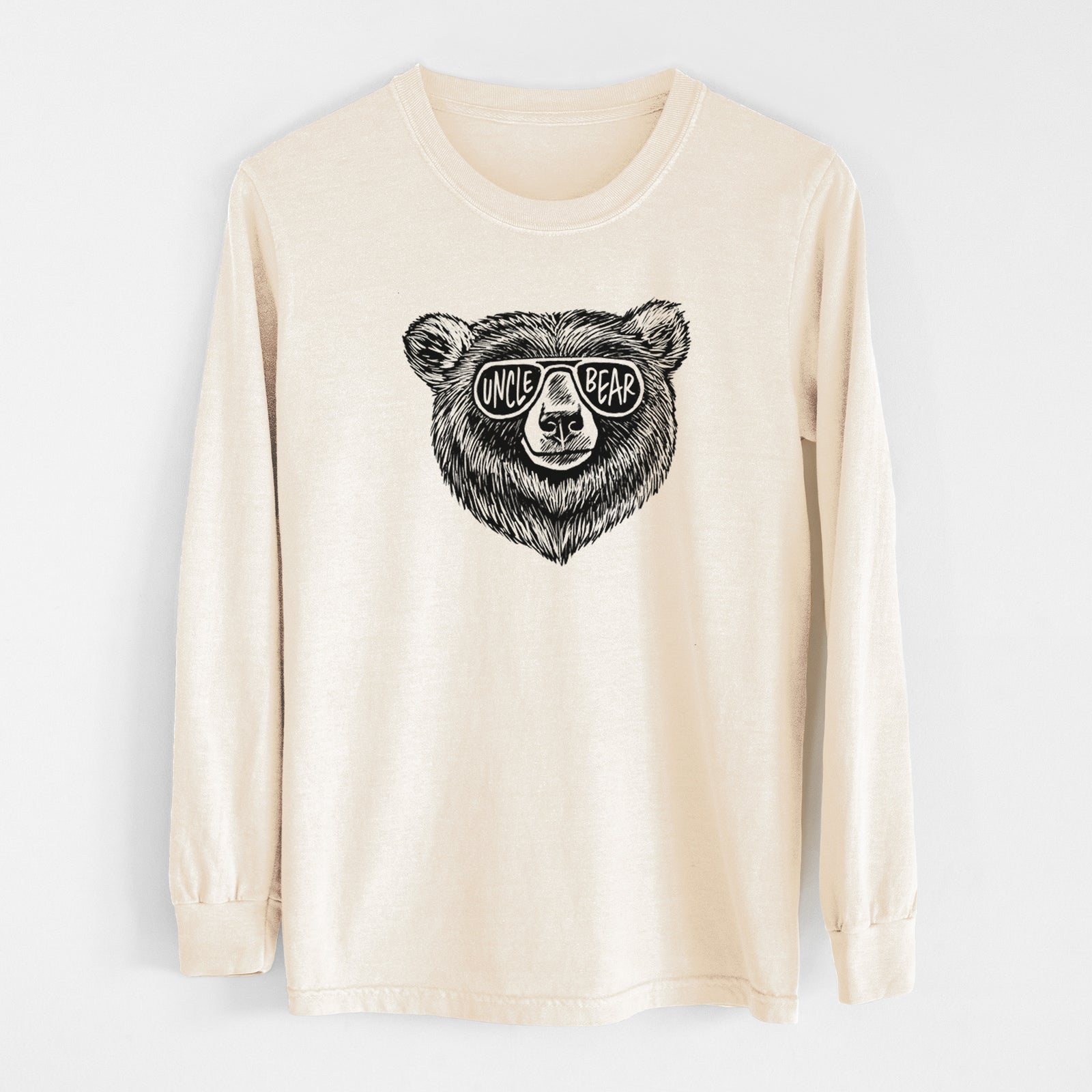 Ivory Comfort Colors long sleeve shirt laid flat, printed with a black ink bear's face wearing sunglasses that read Uncle Bear.