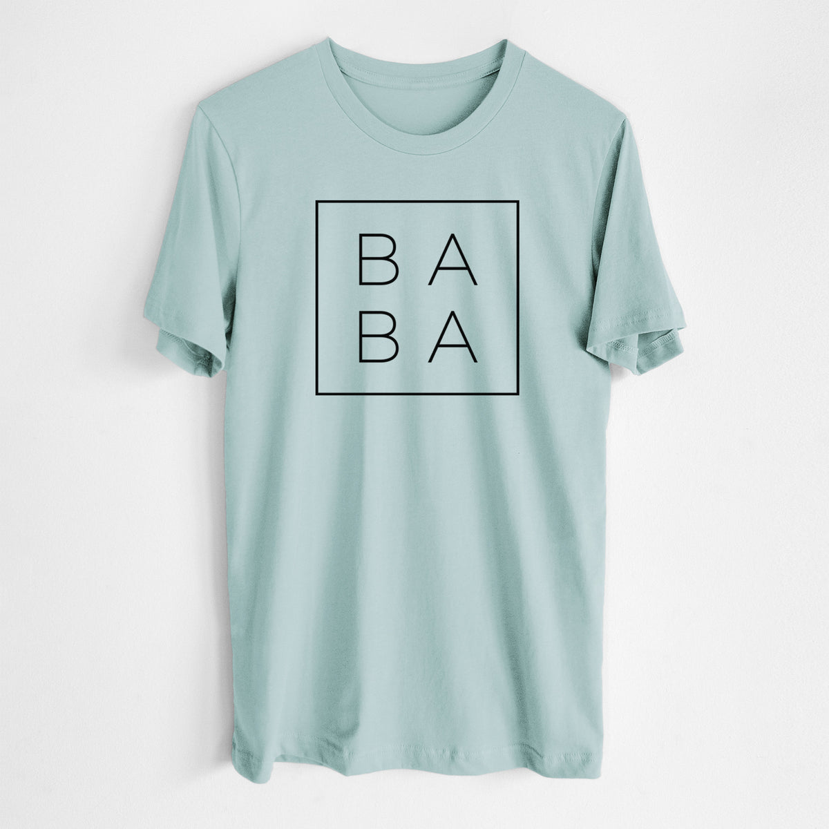Dusty blue lightweight cotton t-shirt laid flat, printed with the word BABA in thin black letters stacked inside a square outline.