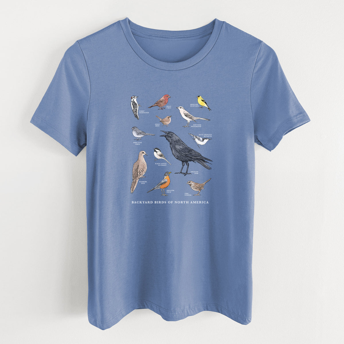 Blue bell women's relaxed fit cotton t-shirt laid flat, printed with a full-color chart of North American backyard birds, each labeled with its species.