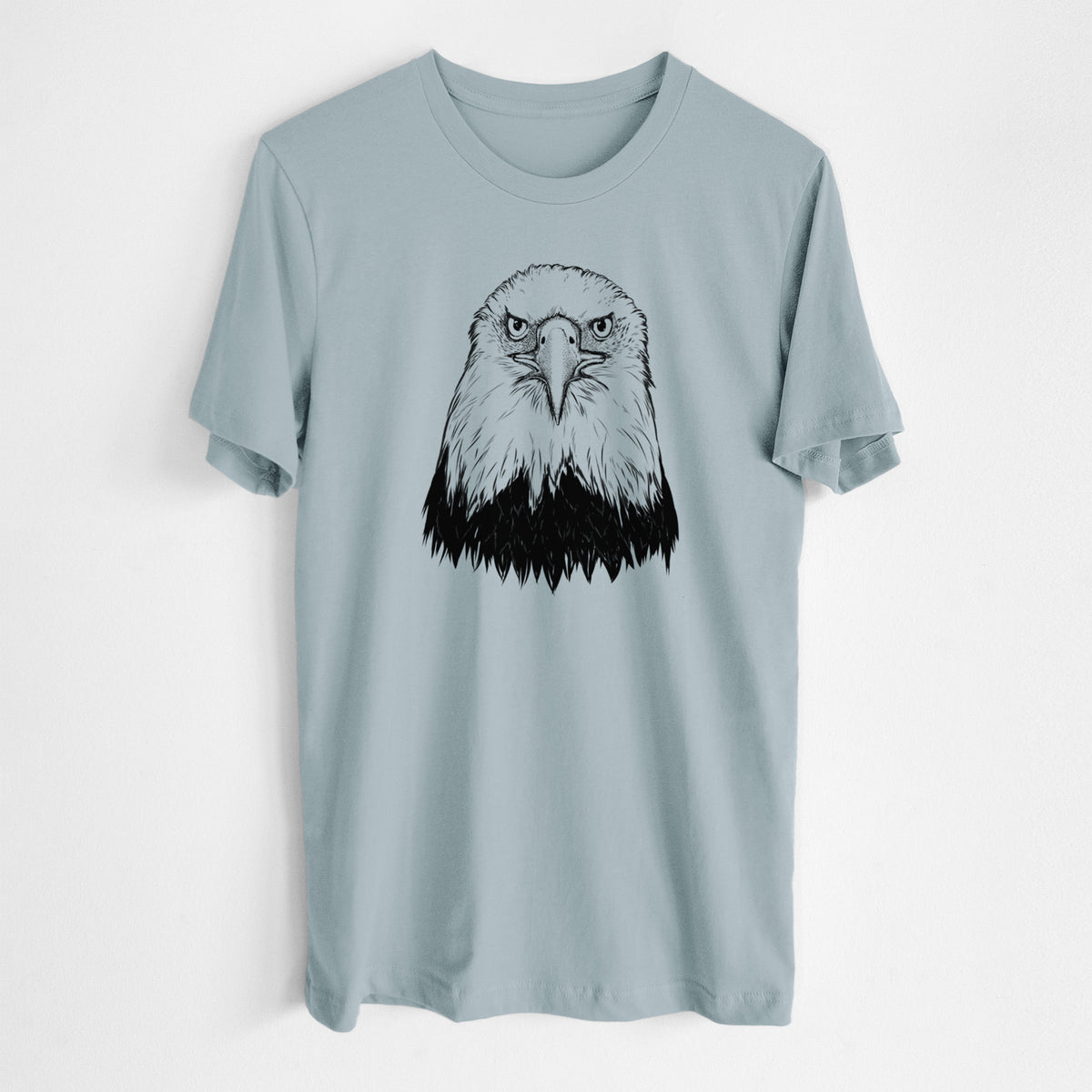 Vintage denim lightweight cotton t-shirt laid flat, printed with a detailed black ink portrait of a bald eagle facing forward.