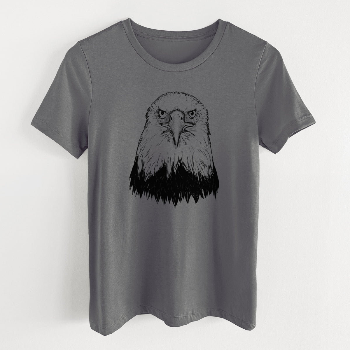 Asphalt women's relaxed fit cotton t-shirt laid flat, printed with a detailed black ink portrait of a bald eagle facing forward.