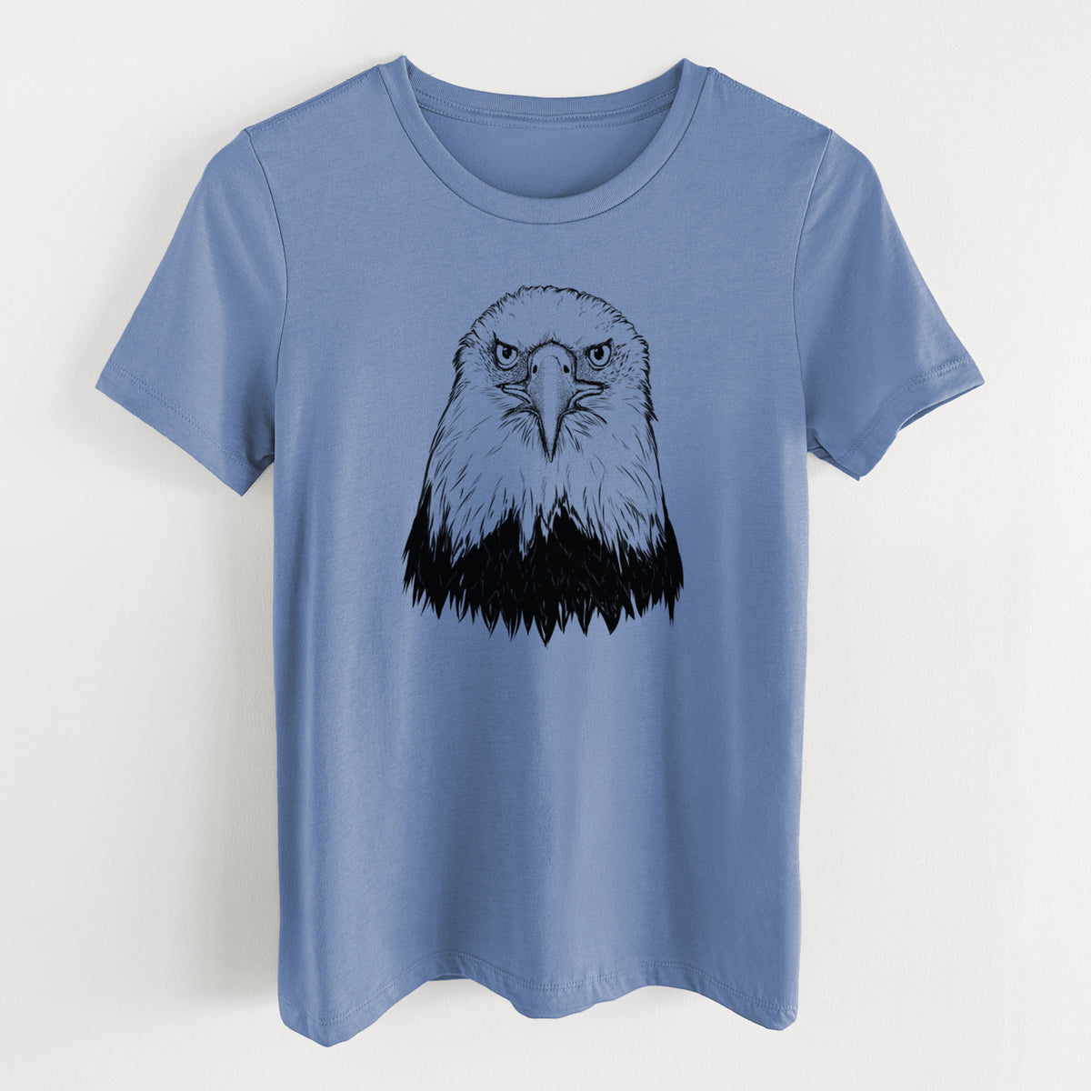 Blue bell women's relaxed fit cotton t-shirt laid flat, printed with a detailed black ink portrait of a bald eagle facing forward.
