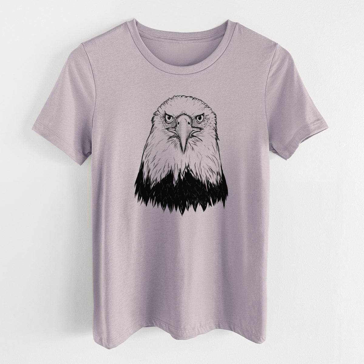 Light violet women's relaxed fit cotton t-shirt laid flat, printed with a detailed black ink portrait of a bald eagle facing forward.