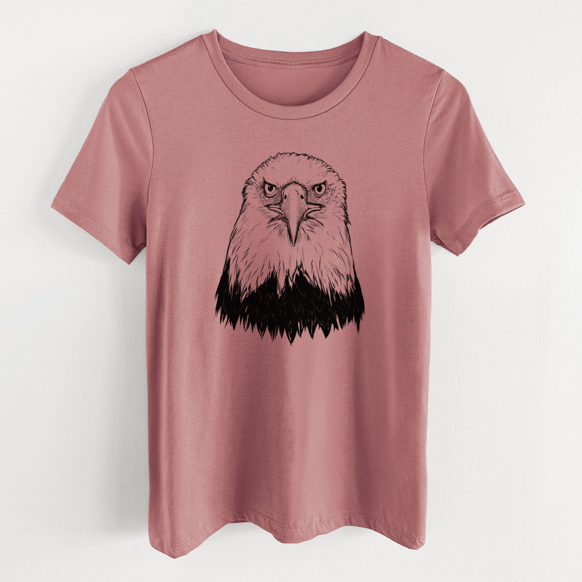Mauve pink women's relaxed fit cotton t-shirt laid flat, printed with a detailed black ink portrait of a bald eagle facing forward.