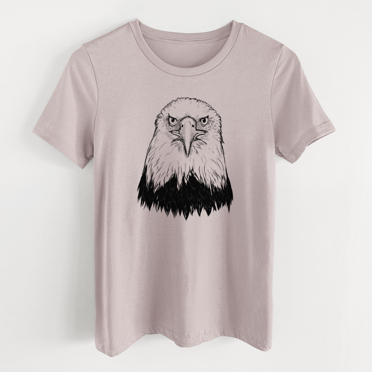 Pink gravel women's relaxed fit cotton t-shirt laid flat, printed with a detailed black ink portrait of a bald eagle facing forward.