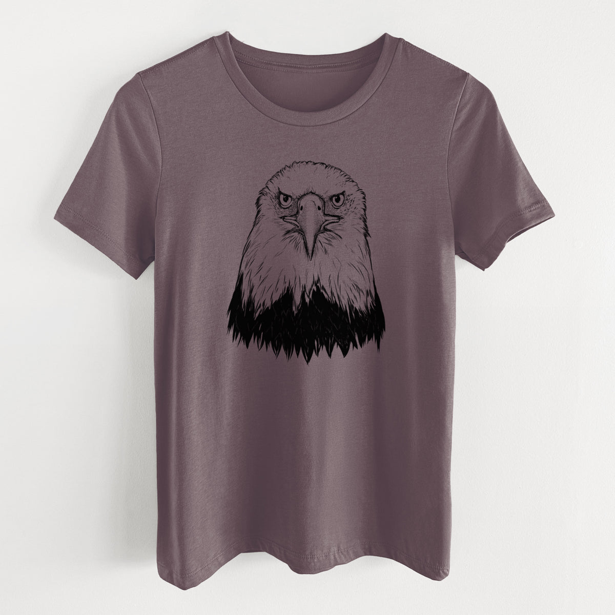 Purple storm women's relaxed fit cotton t-shirt laid flat, printed with a detailed black ink portrait of a bald eagle facing forward.