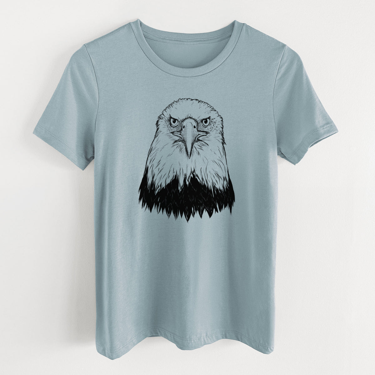 Vintage denim women's relaxed fit cotton t-shirt laid flat, printed with a detailed black ink portrait of a bald eagle facing forward.