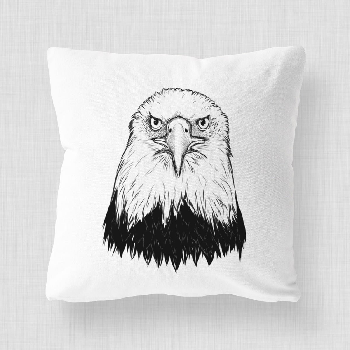 White pillow cover printed with a detailed black ink portrait of a bald eagle facing forward.