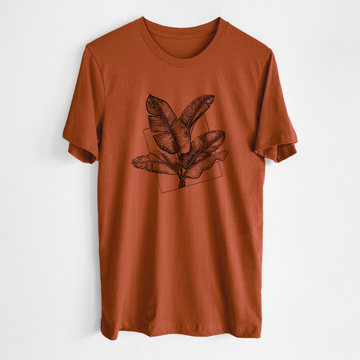 Autumn lightweight cotton t-shirt laid flat, printed with a black ink illustration of banana leaves in front of a square outline.