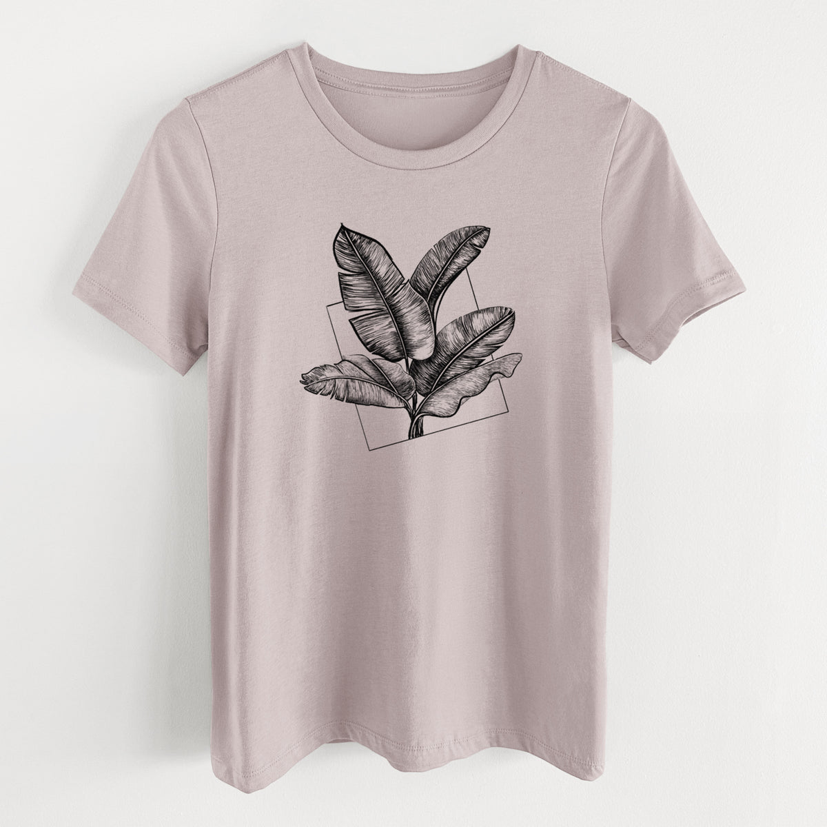 Pink gravel women's relaxed fit cotton t-shirt laid flat, printed with a black ink illustration of banana leaves in front of a square outline.