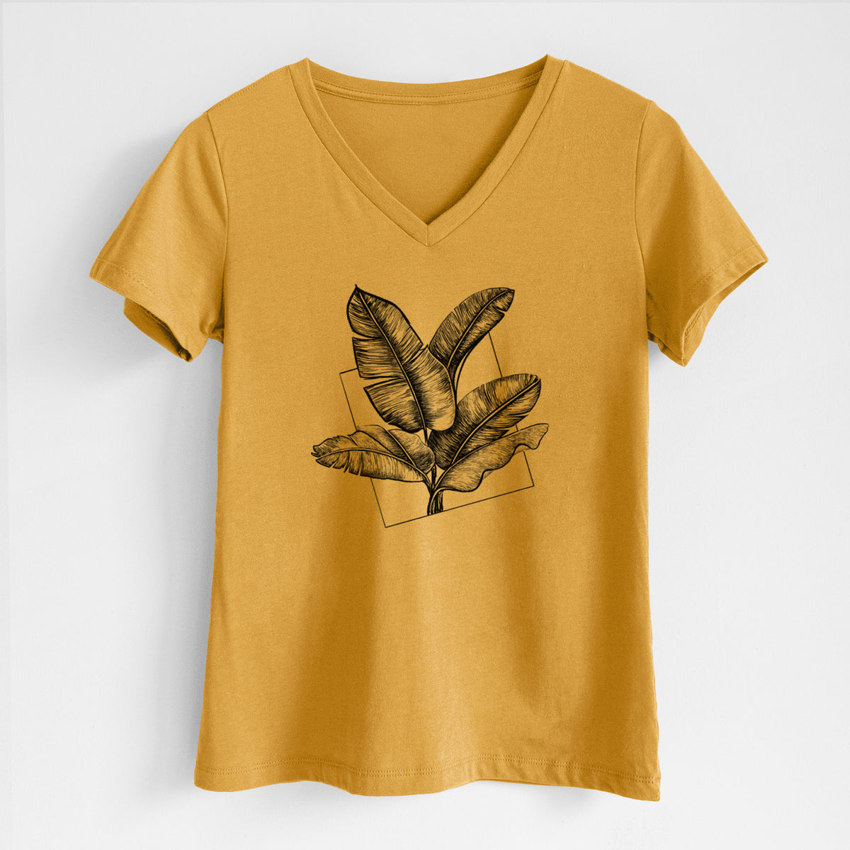Honeycomb yellow women's relaxed fit cotton V-neck t-shirt laid flat, printed with a black ink illustration of banana leaves in front of a square outline.