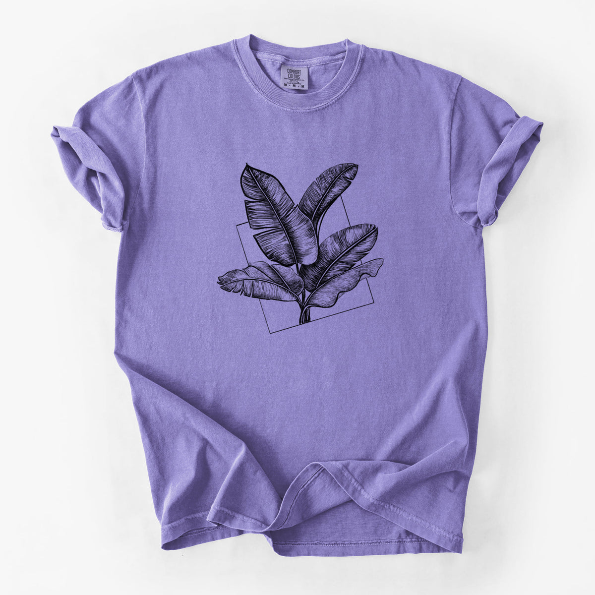 Violet purple Comfort Colors t-shirt laid flat, printed with a black ink illustration of banana leaves in front of a square outline.