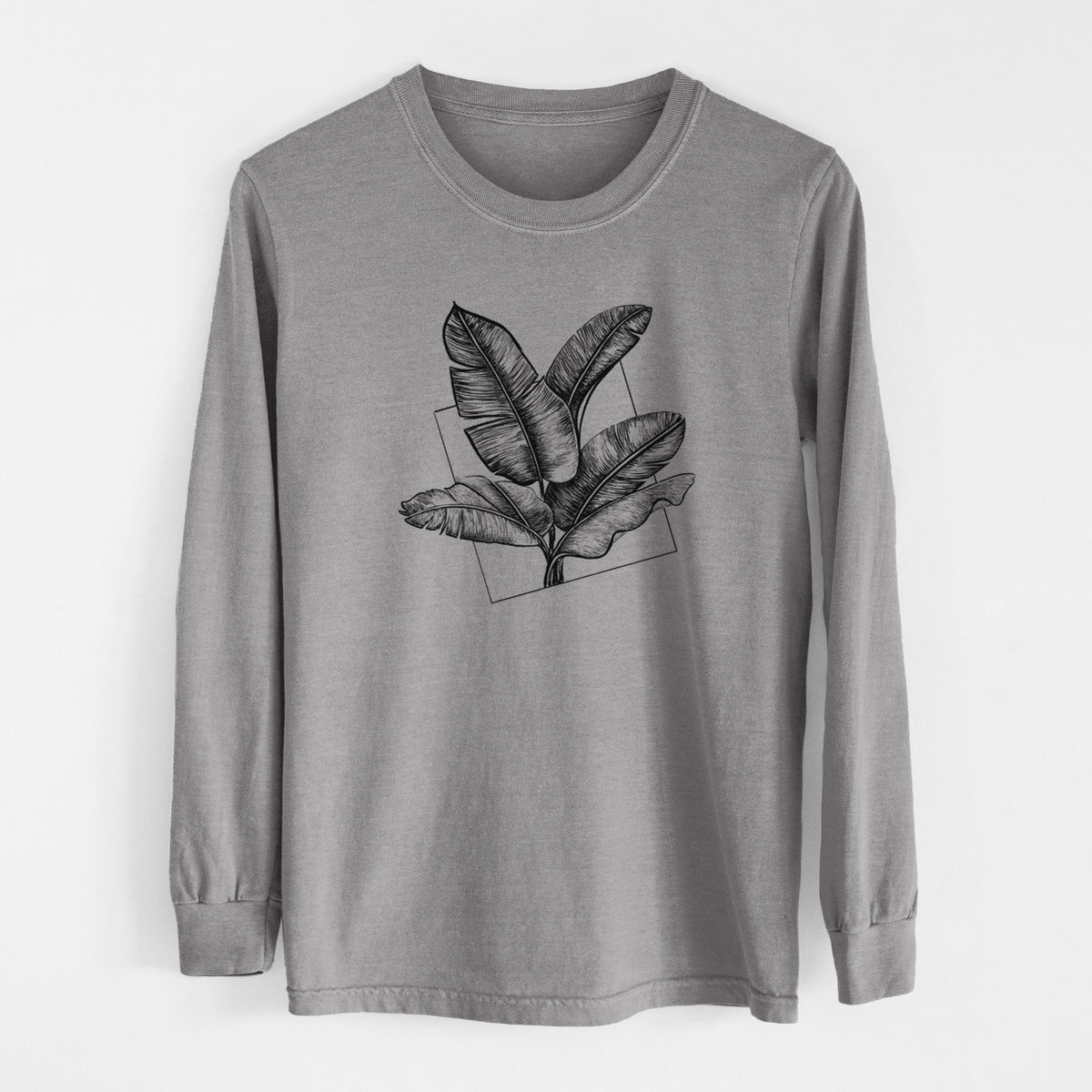 Grey Comfort Colors long sleeve shirt laid flat, printed with a black ink illustration of banana leaves in front of a square outline.