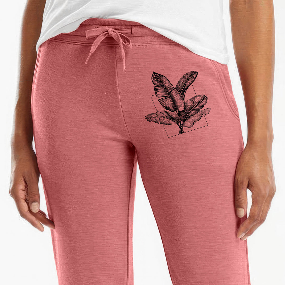 Front of dusty rose Cali Wave sweatpants, printed with a black ink illustration of banana leaves in front of a square outline on the leg.