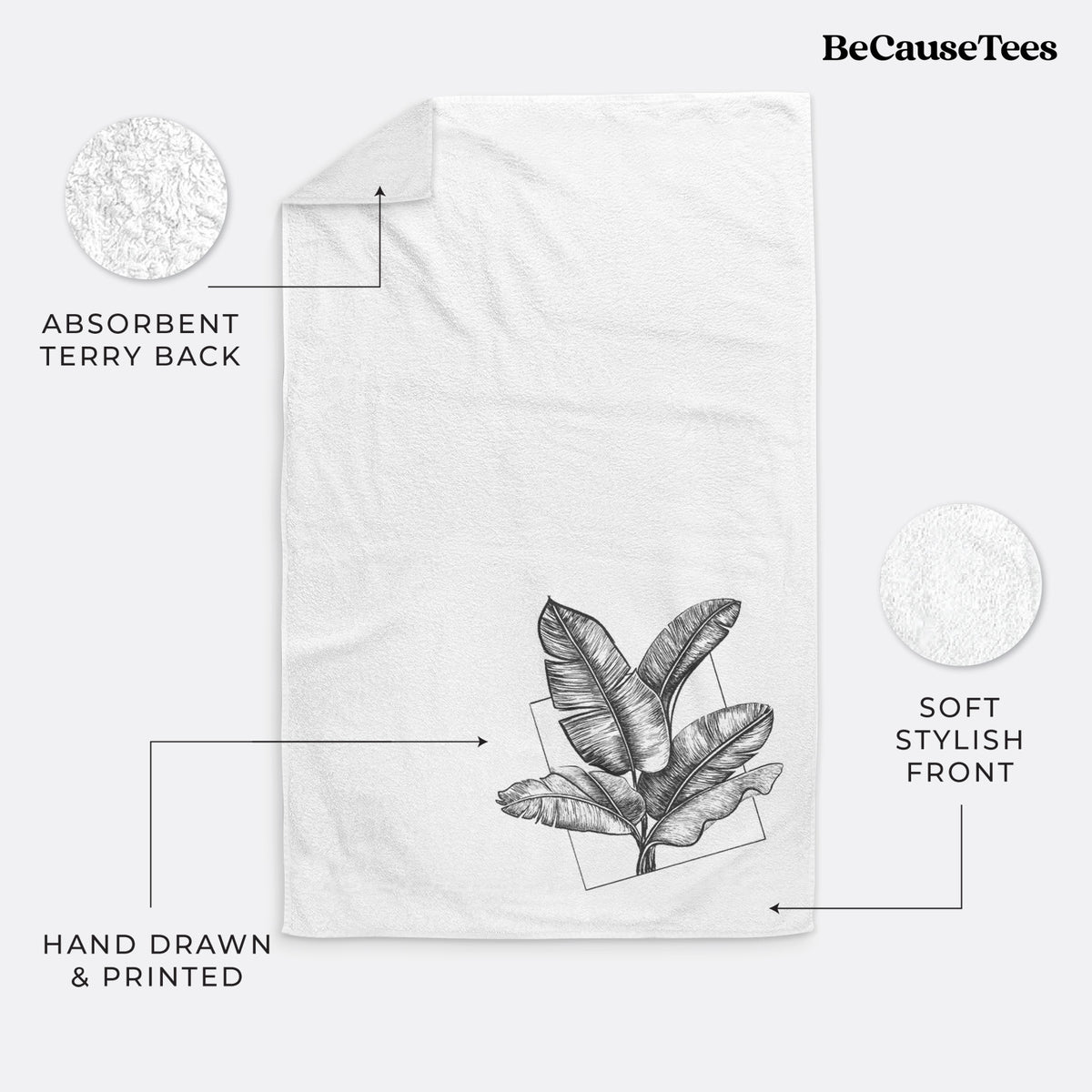 White hand towel printed with a black ink illustration of banana leaves in front of a square outline.